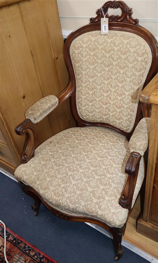 A Victorian mahogany spoonback elbow chair